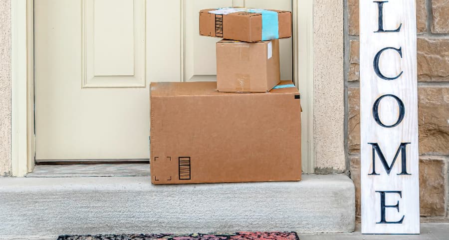 Packages on the doorstep of a home with a welcome sign in Ocala